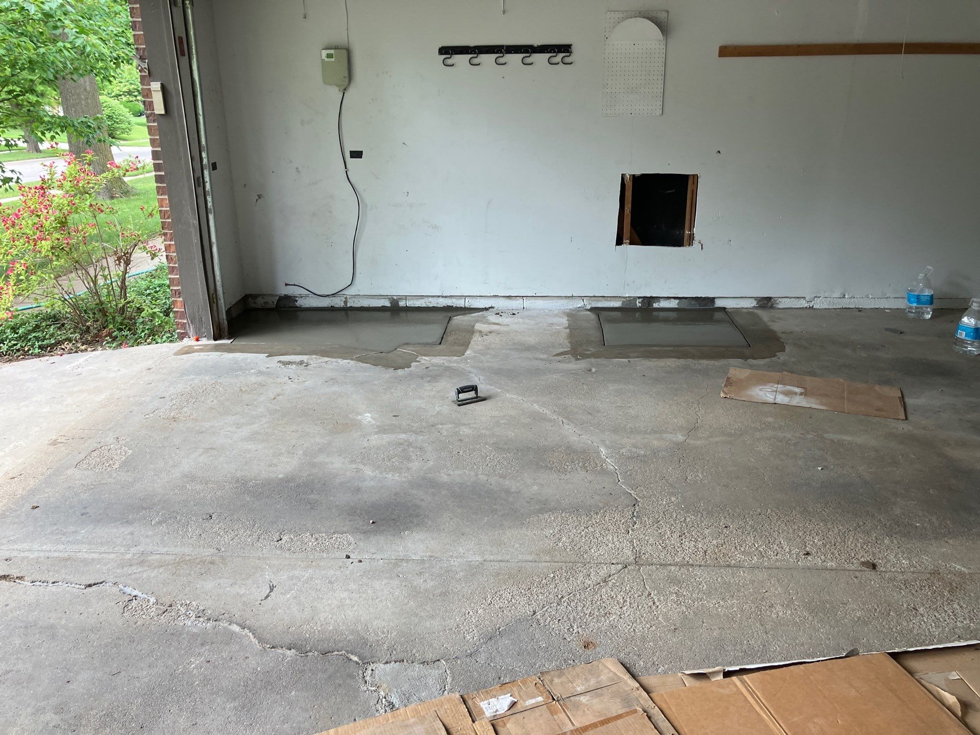 Epp Foundation Repair repairing a cracked garage floor with new concrete patches and leveling.