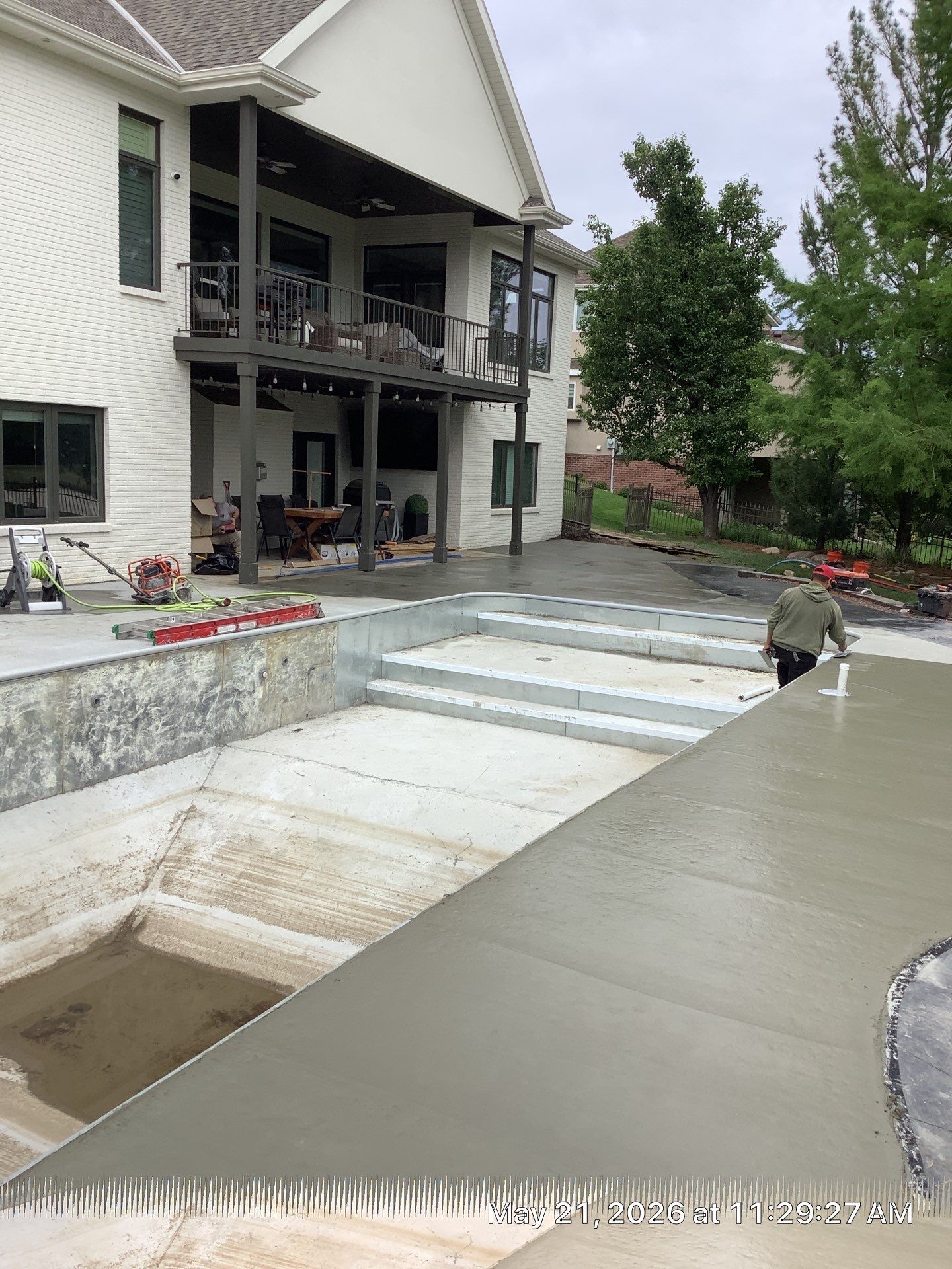 Early warning signs of pool deck settling and tilting around the pool on a Midwest home