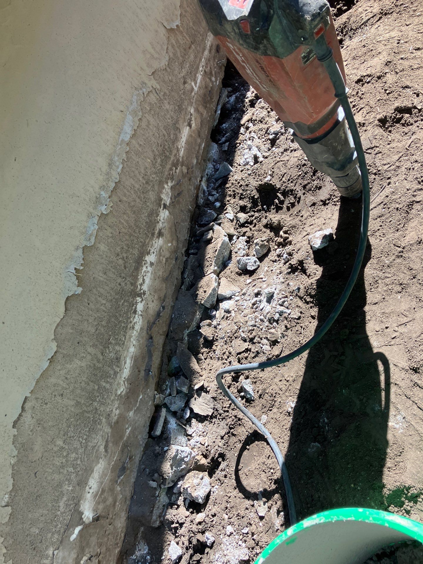 Epp Foundation Repair technician uses a jackhammer for concrete crack repair work in Des Moines, Iowa.